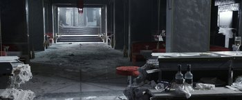 Movie still from “The Darkest Hour” (2011), directed by Chris Gorak – An empty room that has a lot of debris on the floor; Extreme Wide shot, High angle