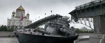 Movie still from “The Darkest Hour” (2011), directed by Chris Gorak – A large ship with a bridge in the background; Extreme Wide shot, Low angle
