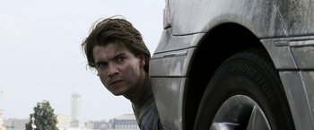 Movie still from “The Darkest Hour” (2011), directed by Chris Gorak – A man leaning against a car with his head on the side of the car; Close Up shot, Low angle