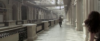 Movie still from “The Darkest Hour” (2011), directed by Chris Gorak – A man walking down a walkway in a building; Extreme Wide shot, High angle