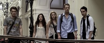 Movie still from “The Darkest Hour” (2011), directed by Chris Gorak – A group of people standing next to a railing; Medium shot, Low angle