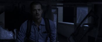 Movie still from “The Darkest Hour” (2011), directed by Chris Gorak – A man in a blue shirt and a black backpack; Close Up shot, Low angle