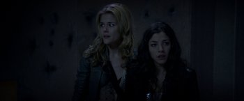 Movie still from “The Darkest Hour” (2011), directed by Chris Gorak – Two young women standing next to each other in the dark; Close Up shot, Low angle