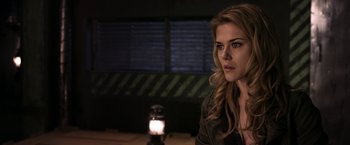 Movie still from “The Darkest Hour” (2011), directed by Chris Gorak – A beautiful young woman sitting in front of a lamp; Close Up shot, Over the shoulder angle