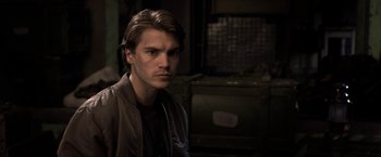 Movie still from “The Darkest Hour” (2011), directed by Chris Gorak – A man with long brown hair is looking at the camera; Close Up shot, Over the shoulder angle