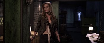 Movie still from “The Darkest Hour” (2011), directed by Chris Gorak – A beautiful young woman holding a purse while standing next to a building; Medium shot, Over the shoulder angle