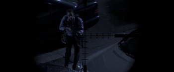Movie still from “The Darkest Hour” (2011), directed by Chris Gorak – A man holding a gun while standing next to a car at night; Wide shot, Over the shoulder angle