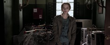 Movie still from “The Darkest Hour” (2011), directed by Chris Gorak – A woman standing in front of a bunch of bikes; Medium shot, Over the shoulder angle