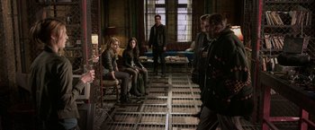 Movie still from “The Darkest Hour” (2011), directed by Chris Gorak – A group of people sitting in a room; Wide shot, High angle