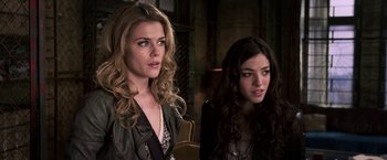 Movie still from “The Darkest Hour” (2011), directed by Chris Gorak – Two young women sitting next to each other in a room; Close Up shot, Over the shoulder angle