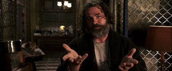 Movie still from “The Darkest Hour” (2011), directed by Chris Gorak – A man with long hair and a gray beard is talking; Close Up shot, Low angle