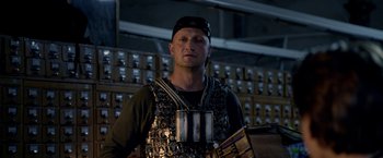 Movie still from “The Darkest Hour” (2011), directed by Chris Gorak – A man wearing a metal vest and a hat; Medium shot, Low angle