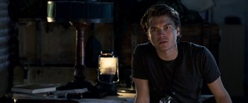 Movie still from “The Darkest Hour” (2011), directed by Chris Gorak – A man sitting on a table in front of a lamp; Close Up shot, Over the shoulder angle