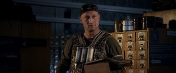 Movie still from “The Darkest Hour” (2011), directed by Chris Gorak – A man in a black hat holding a metal object; Medium shot, Low angle