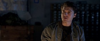 Movie still from “The Darkest Hour” (2011), directed by Chris Gorak – A young man in a black shirt and a brown jacket; Close Up shot, Over the shoulder angle