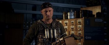 Movie still from “The Darkest Hour” (2011), directed by Chris Gorak – A man wearing a helmet and holding an object in his hands; Medium shot, Low angle