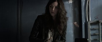 Movie still from “The Darkest Hour” (2011), directed by Chris Gorak – A woman with long hair wearing a leather jacket; Close Up shot, Low angle
