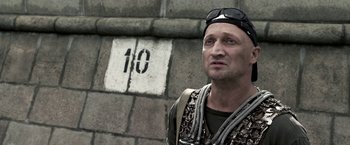 Movie still from “The Darkest Hour” (2011), directed by Chris Gorak – A man standing in front of a brick wall; Close Up shot, High angle