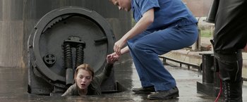 Movie still from “The Darkest Hour” (2011), directed by Chris Gorak – A man helping a woman out of the water; Medium shot, Overhead angle