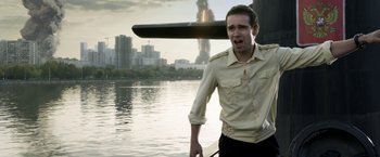 Movie still from “The Darkest Hour” (2011), directed by Chris Gorak – A man standing in front of a body of water; Medium shot, Over the shoulder angle