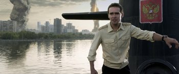 Movie still from “The Darkest Hour” (2011), directed by Chris Gorak – A man standing in front of a body of water; Medium shot, Over the shoulder angle