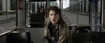Movie still from “The Darkest Hour” (2011), directed by Chris Gorak – A man and a woman riding a bus together; Close Up shot, Low angle