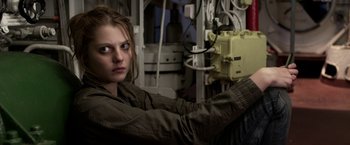 Movie still from “The Darkest Hour” (2011), directed by Chris Gorak – A woman in a jacket is holding a control panel; Medium shot, High angle