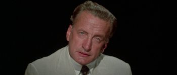 Movie still from “The Day of the Dolphin” (1973), directed by Mike Nichols – An older man wearing a white shirt and a tie; Close Up shot, High angle