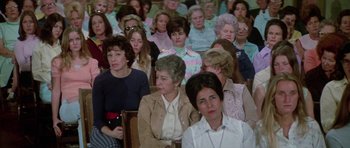 Movie still from “The Day of the Dolphin” (1973), directed by Mike Nichols – A group of people sitting in a room; Wide shot, High angle