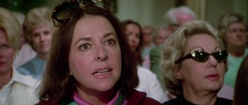 Movie still from “The Day of the Dolphin” (1973), directed by Mike Nichols – An older woman is looking at the camera; Close Up shot, Over the shoulder angle