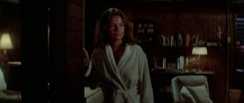 Movie still from “The Day of the Dolphin” (1973), directed by Mike Nichols – A woman wearing a robe standing in a room; Medium shot, Low angle