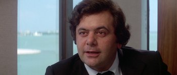 Movie still from “The Day of the Dolphin” (1973), directed by Mike Nichols – A person wearing a suit and tie; Close Up shot, Low angle