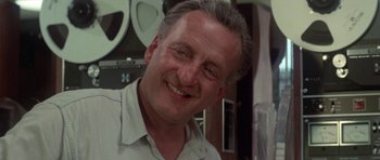 Movie still from “The Day of the Dolphin” (1973), directed by Mike Nichols – A person smiling for the camera; Close Up shot, Low angle
