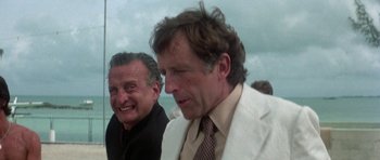 Movie still from “The Day of the Dolphin” (1973), directed by Mike Nichols – Two men in white jackets and a brown tie; Close Up shot, Over the shoulder angle