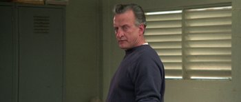 Movie still from “The Day of the Dolphin” (1973), directed by Mike Nichols – A person standing in a room; Close Up shot, Low angle