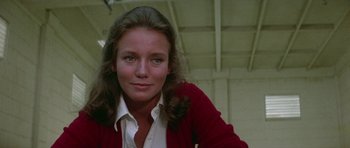 Movie still from “The Day of the Dolphin” (1973), directed by Mike Nichols – A woman in a white shirt and a red sweater; Close Up shot, Low angle