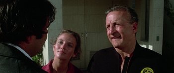 Movie still from “The Day of the Dolphin” (1973), directed by Mike Nichols – A man and a woman standing next to each other in a room; Close Up shot, Low angle