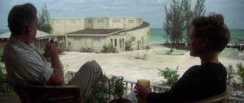 Movie still from “The Day of the Dolphin” (1973), directed by Mike Nichols – Two people sitting on a deck with a cup of coffee; Wide shot, Over the shoulder angle
