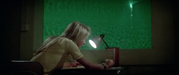 Movie still from “The Day of the Dolphin” (1973), directed by Mike Nichols – A woman sitting in front of a computer desk; Medium shot, High angle