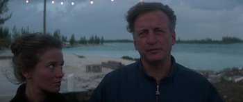 Movie still from “The Day of the Dolphin” (1973), directed by Mike Nichols – A person near a body of water; Close Up shot, Low angle