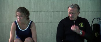 Movie still from “The Day of the Dolphin” (1973), directed by Mike Nichols – A man and a woman sitting next to each other; Medium shot, Over the shoulder angle