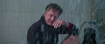 Movie still from “The Day of the Dolphin” (1973), directed by Mike Nichols – A man sitting in front of a window with his hand on his face; Close Up shot, Low angle