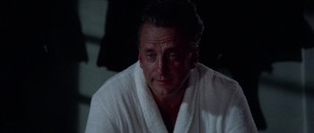 Movie still from “The Day of the Dolphin” (1973), directed by Mike Nichols – A person wearing a robe in the dark; Close Up shot, Low angle