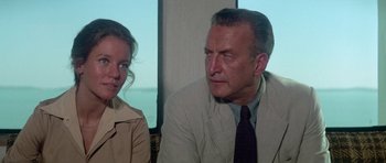 Movie still from “The Day of the Dolphin” (1973), directed by Mike Nichols – An older man and a young woman sitting next to each other; Close Up shot, Over the shoulder angle