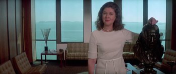 Movie still from “The Day of the Dolphin” (1973), directed by Mike Nichols – A woman standing in front of a window in a room; Medium shot, Low angle