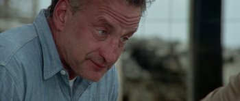 Movie still from “The Day of the Dolphin” (1973), directed by Mike Nichols – A man's face looking at the camera; Close Up shot, Low angle