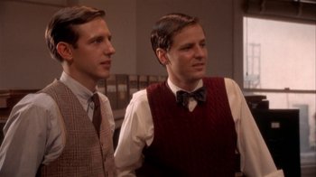 Movie still from “The Day of the Locust” (1975), directed by John Schlesinger – A couple of men standing next to each other; Medium shot, Over the shoulder angle