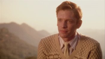 Movie still from “The Day of the Locust” (1975), directed by John Schlesinger – A man wearing a sweater and a yellow tie; Close Up shot, Low angle