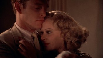 Movie still from “The Day of the Locust” (1975), directed by John Schlesinger – A man and a woman are kissing in a room; Close Up shot, Low angle