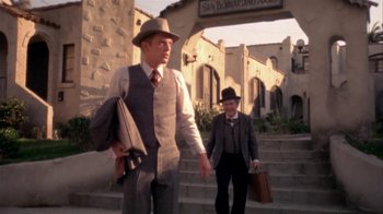 Movie still from “The Day of the Locust” (1975), directed by John Schlesinger – A man and a woman walking down a set of stairs; Wide shot, Low angle